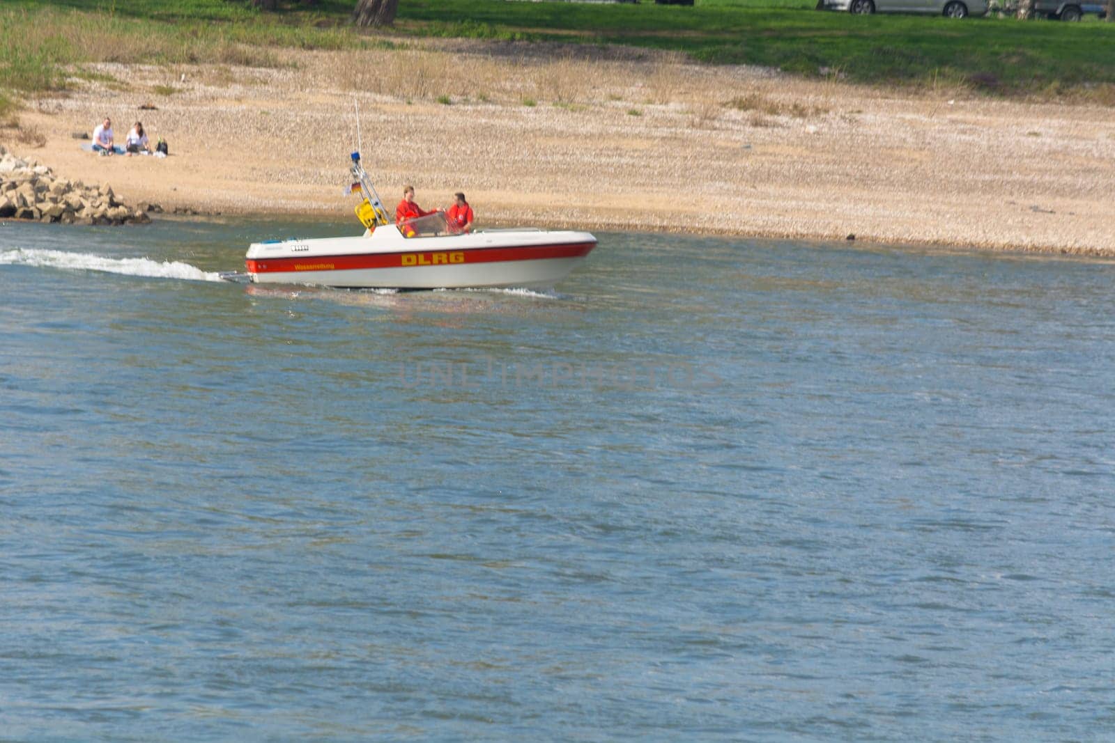DUESSELDORF, NRW, GERMANY - APRIL 02, 2017:  A DLRG boat on the river Rhine. Lifeguard of the German Lifeguard Association DLRG in a lifeboat on the way to the site on the Rhine. The DLRG (German Lifesaving Society) is an independent NPO (nonprofit organization) on a voluntary basis.