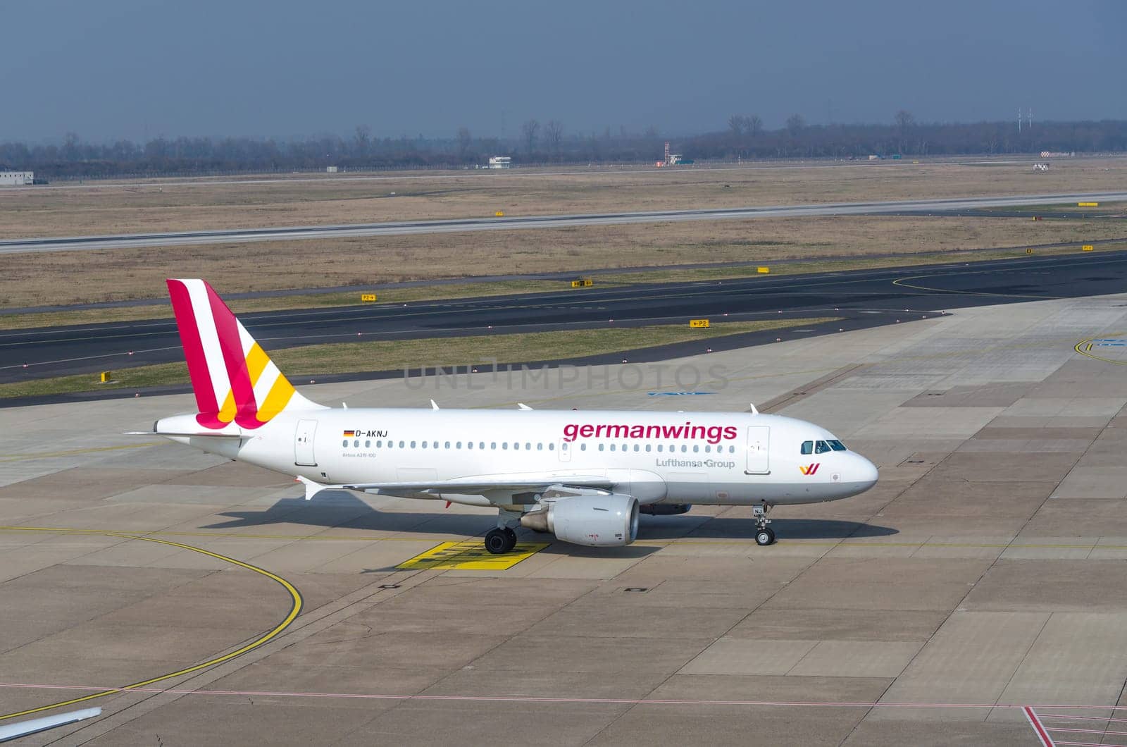 DUSSELDORF, NRW, GERMANY - MARCH 18, 2015:  Up, Airplane Dusseldorf. View of the tarmac. Large passenger airplane at the gate.