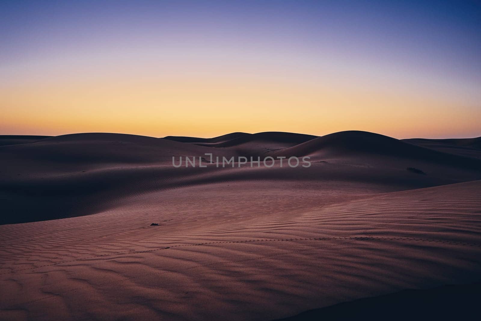 Sand dunes against sky before sunrise. Desert Wahiba Sands in Oman.