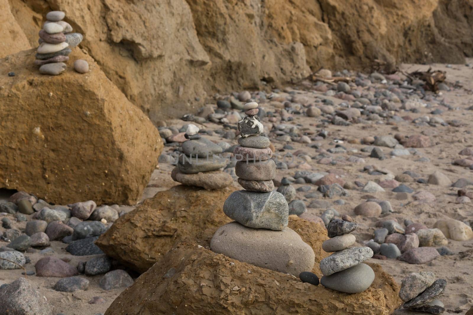 Stones stacked on top of each other on the beach on the Baltic Sea with so-called chicken gods.