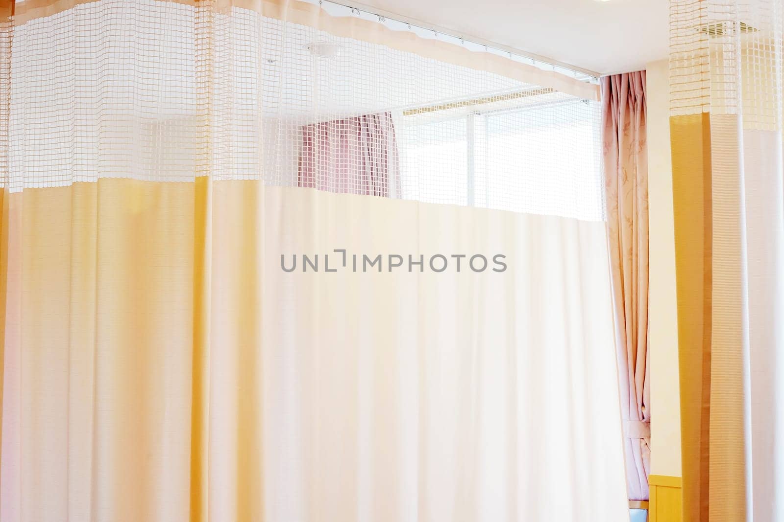Medical curtain hanging from a railing in a hospital room, Privacy curtain