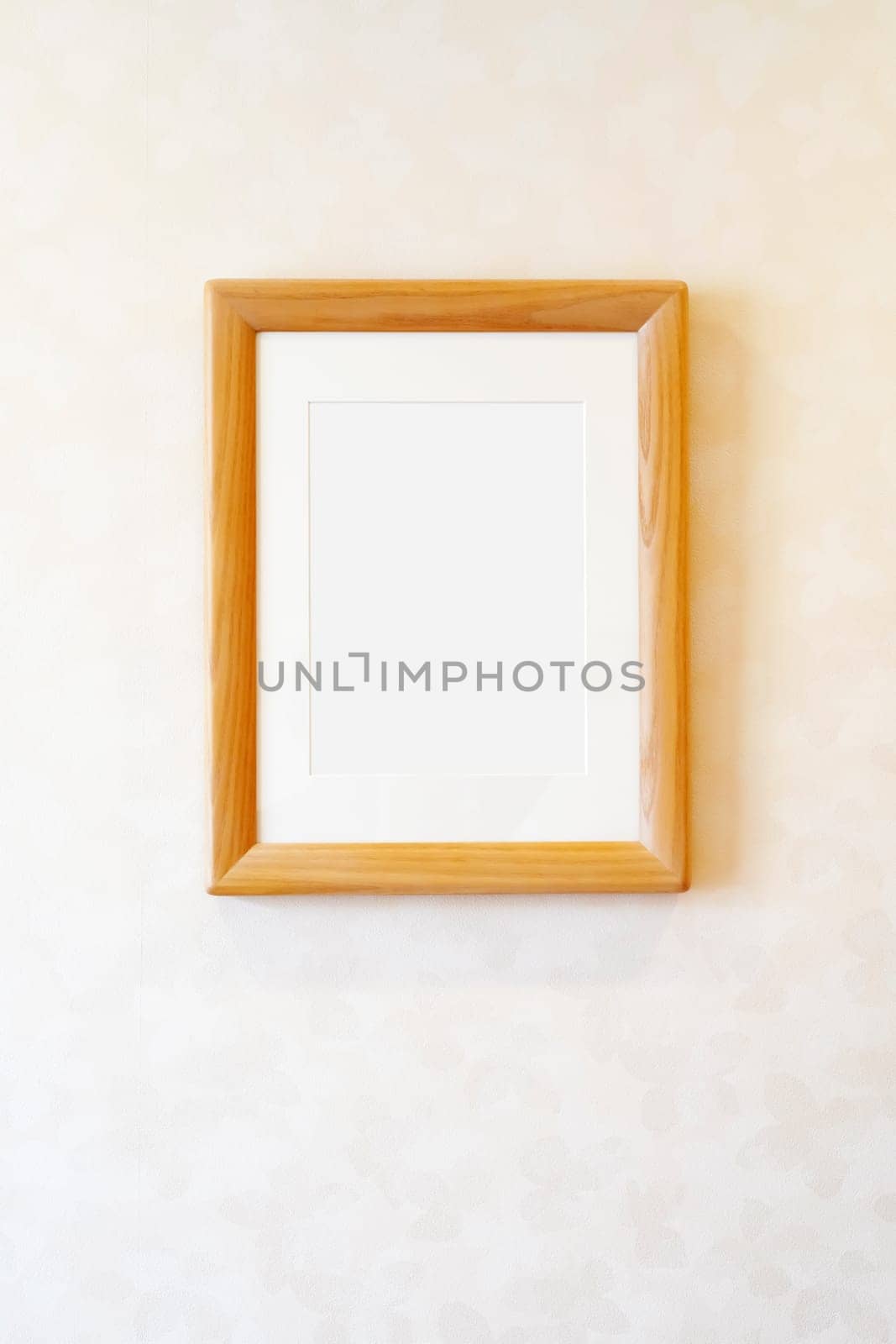 Blank wooden picture frame on the wall, rectangular photo frame with shadow