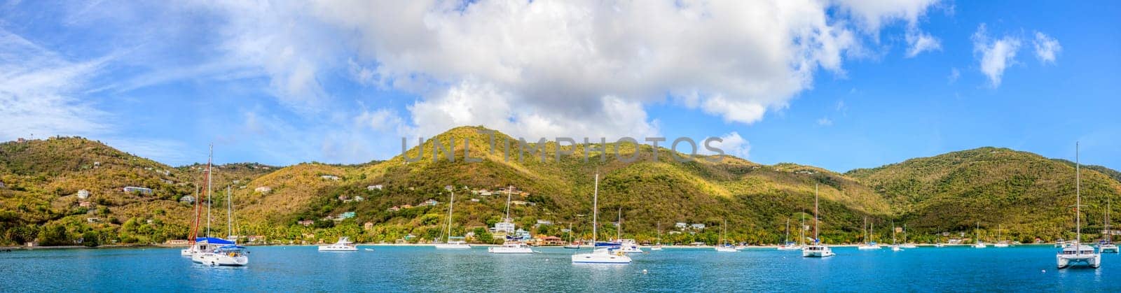 Panoramic view of a harbor with anchored sailboats in BVI