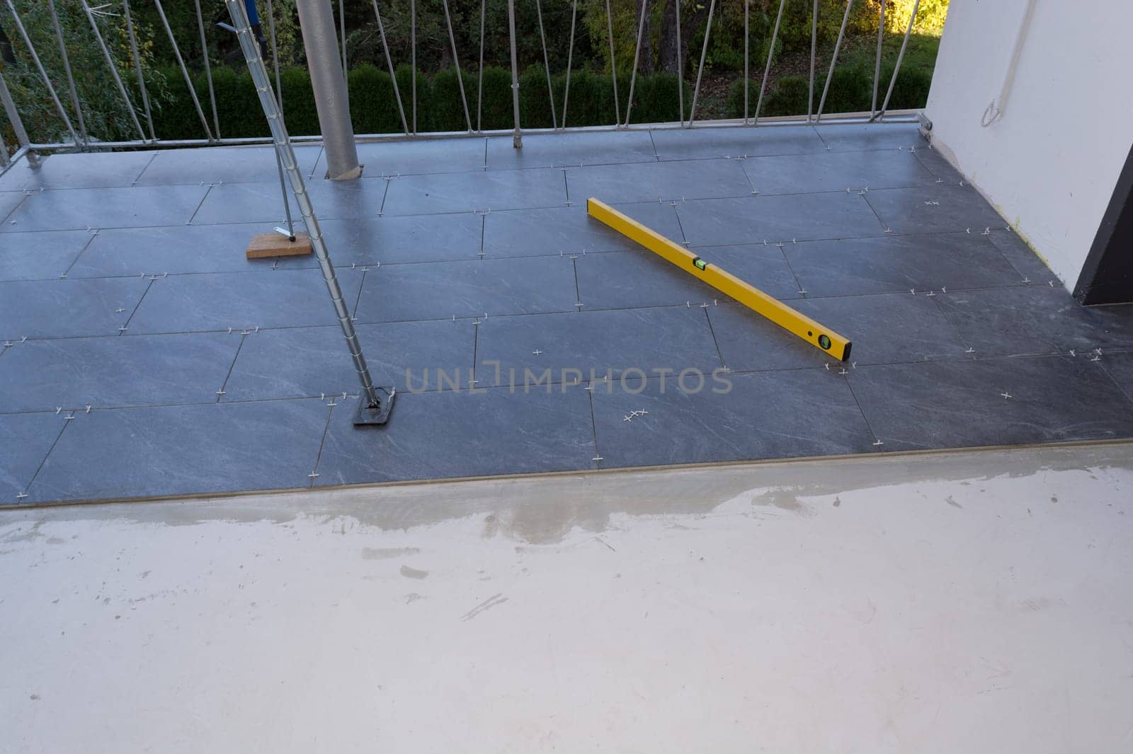Balcony floor tiles installation. Laying tiles from porcelain. Interior remodeling theme.