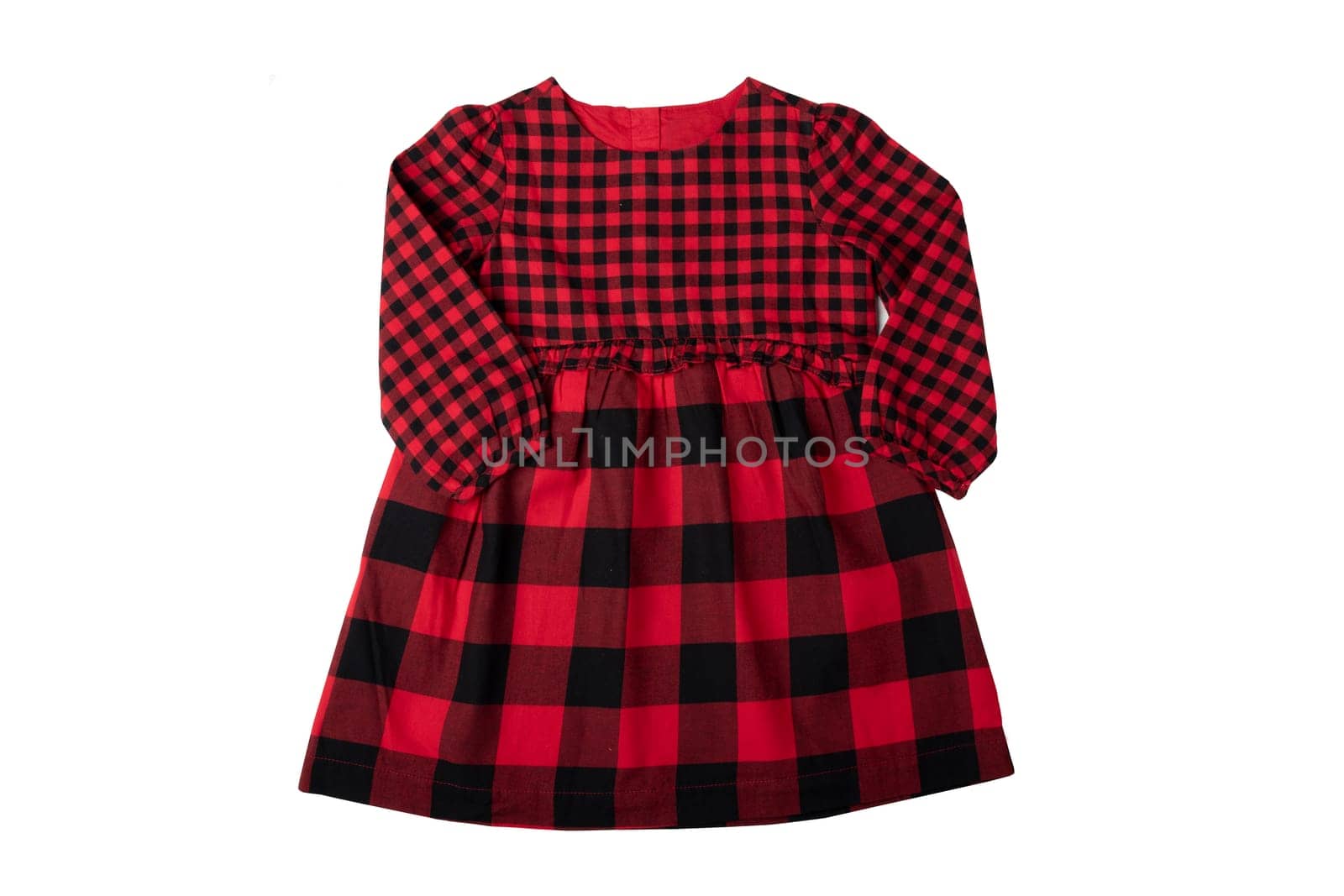 Clothes for children. A beautiful red and black checkered girl dress isolated on a white background. Children fashion.