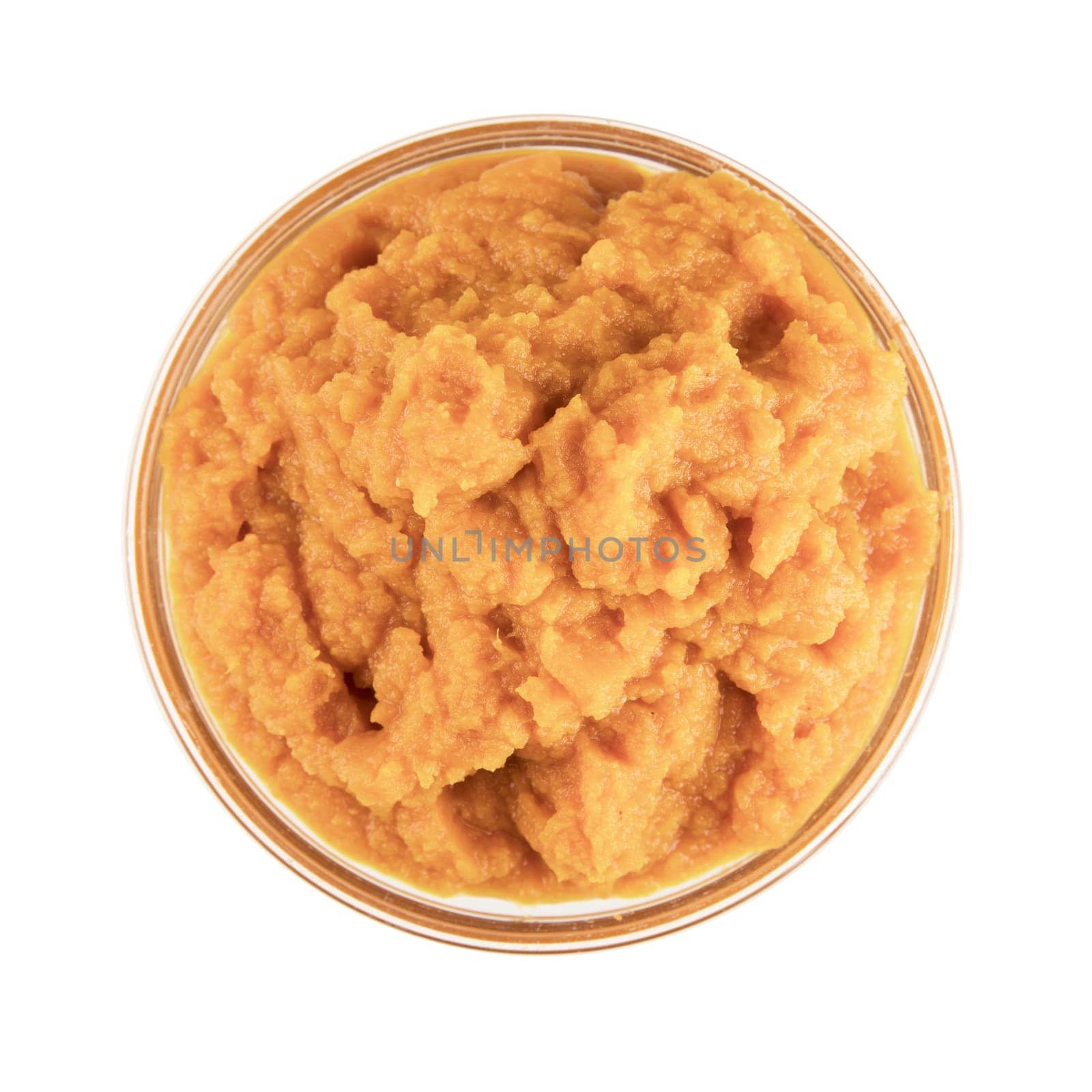 Glass bowl of pumpkin puree isolated on a white background