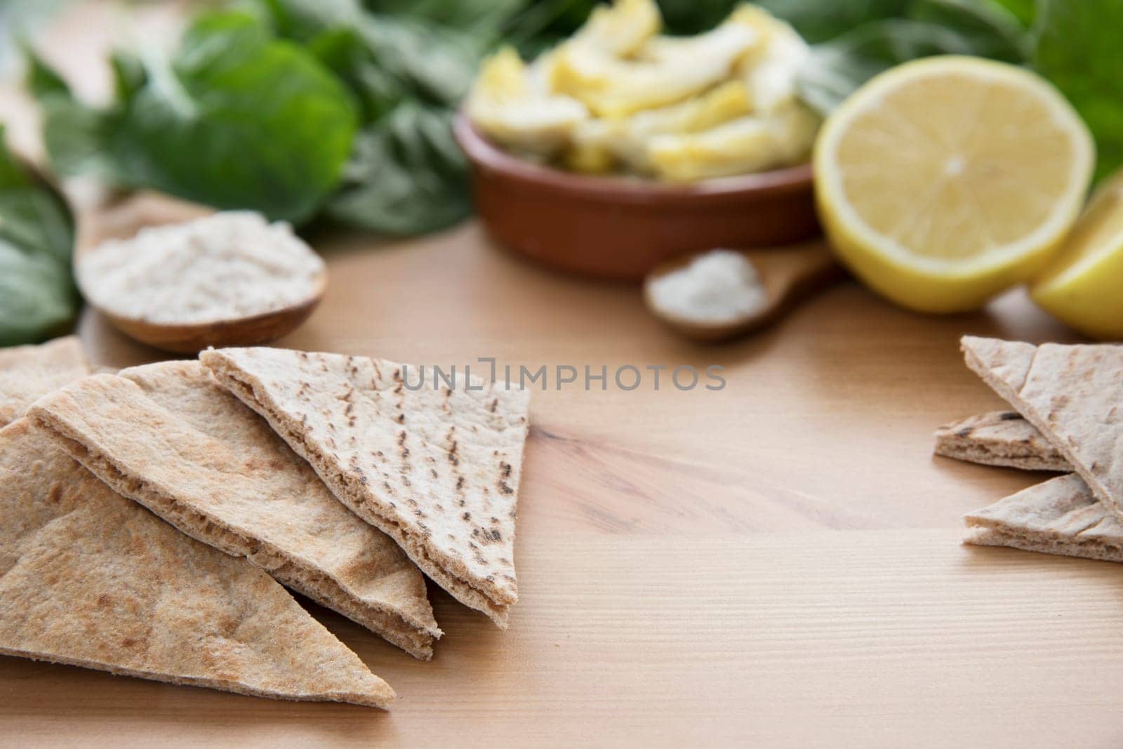 Artichoke hearts, spinach, lemon and other ingredients for vegan dip.