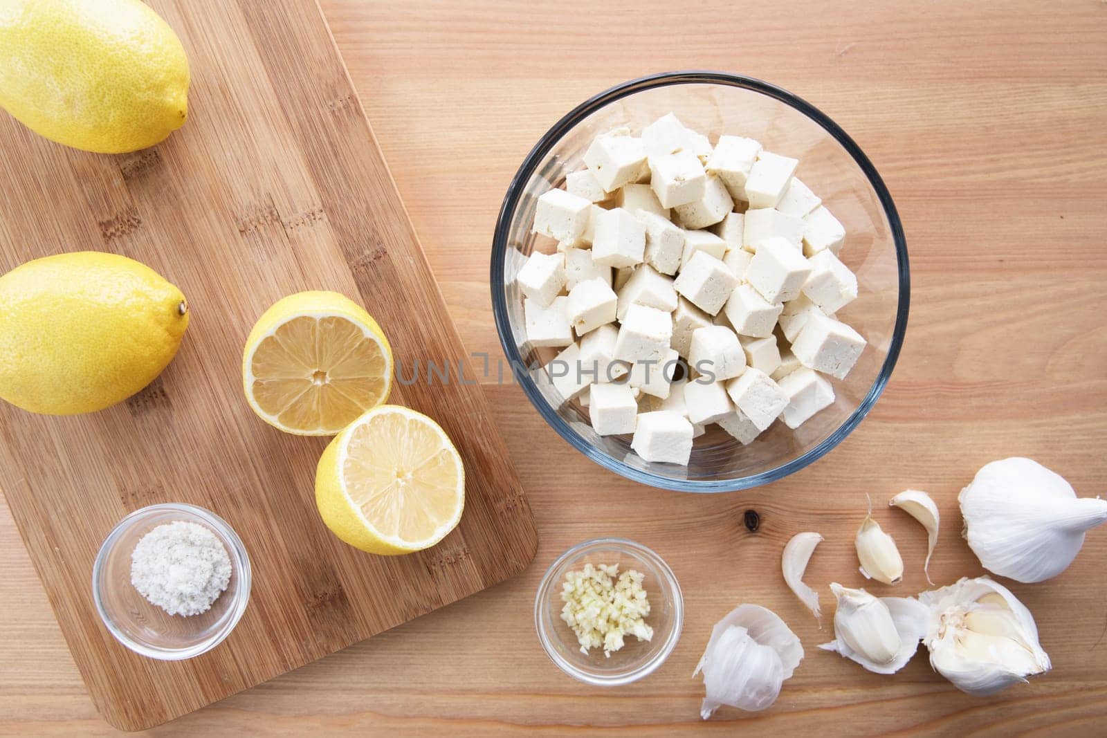 Tofu, lemons, garlic and salt for marinaded tofu  for salads.