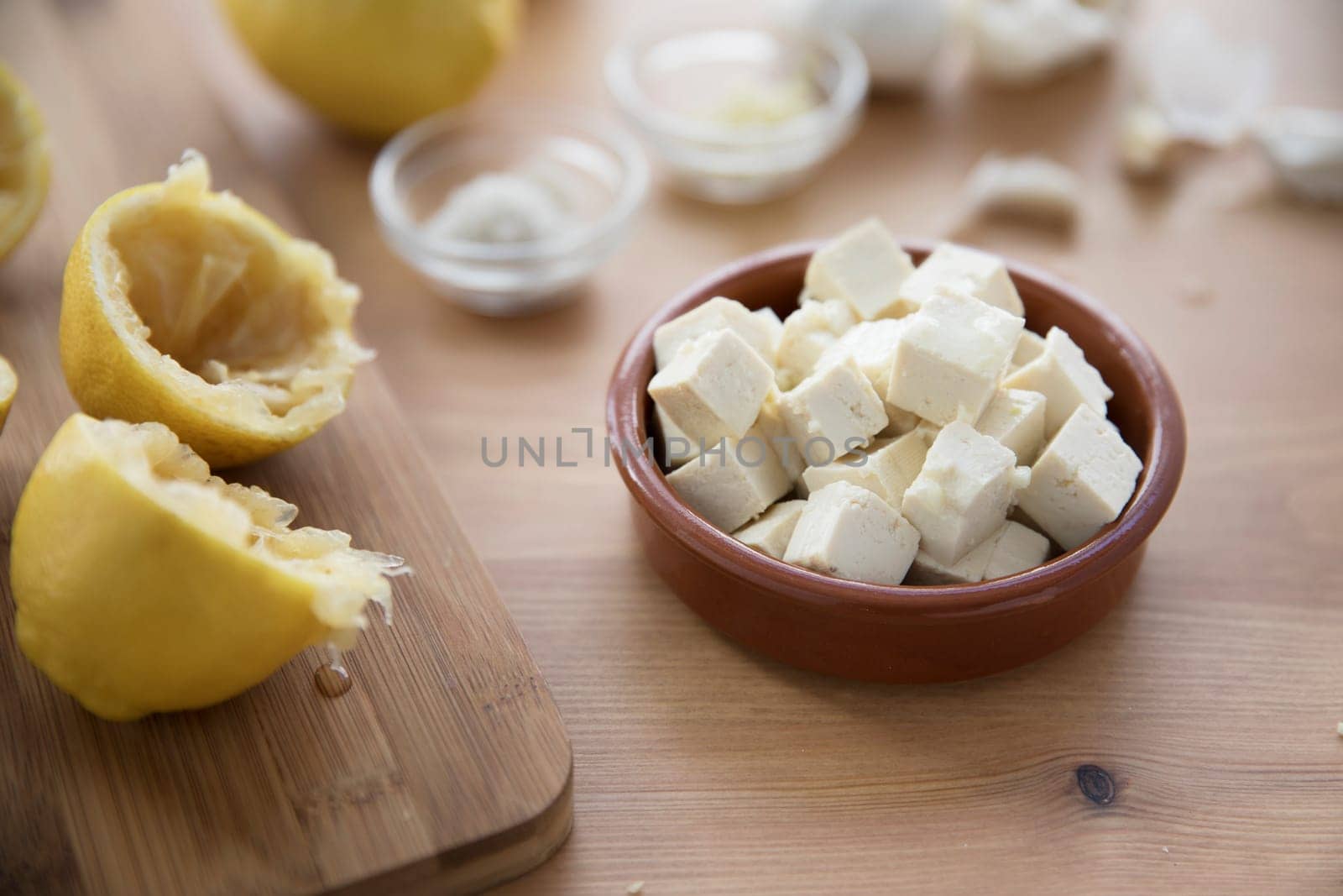 Tofu, lemons, garlic and salt for marinaded tofu  for salads.