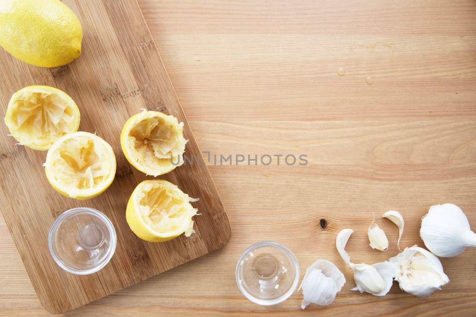 Cooking with lemon and garlic, flat lay with copy space.