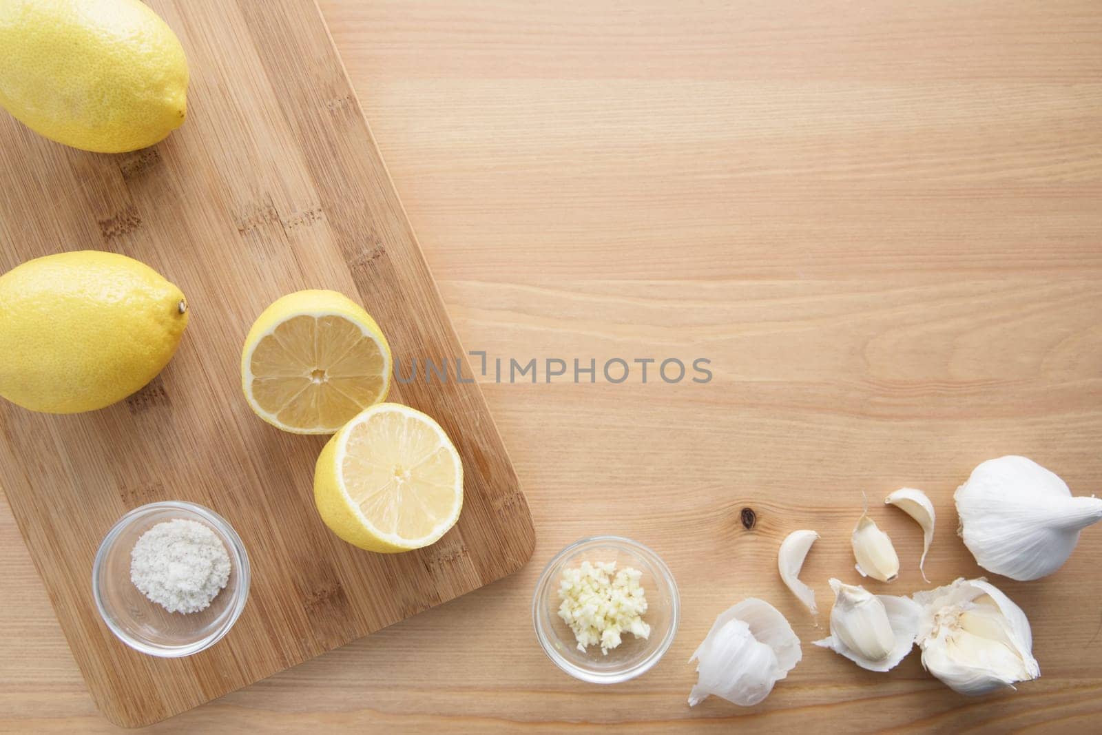 Cooking with lemon and garlic, flat lay with copy space.