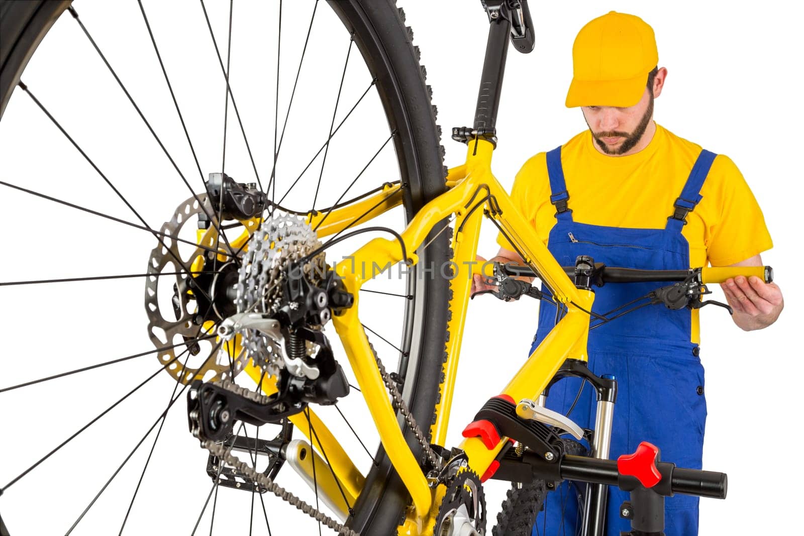 bicycle mechanic straightening handlebar on mountain bike