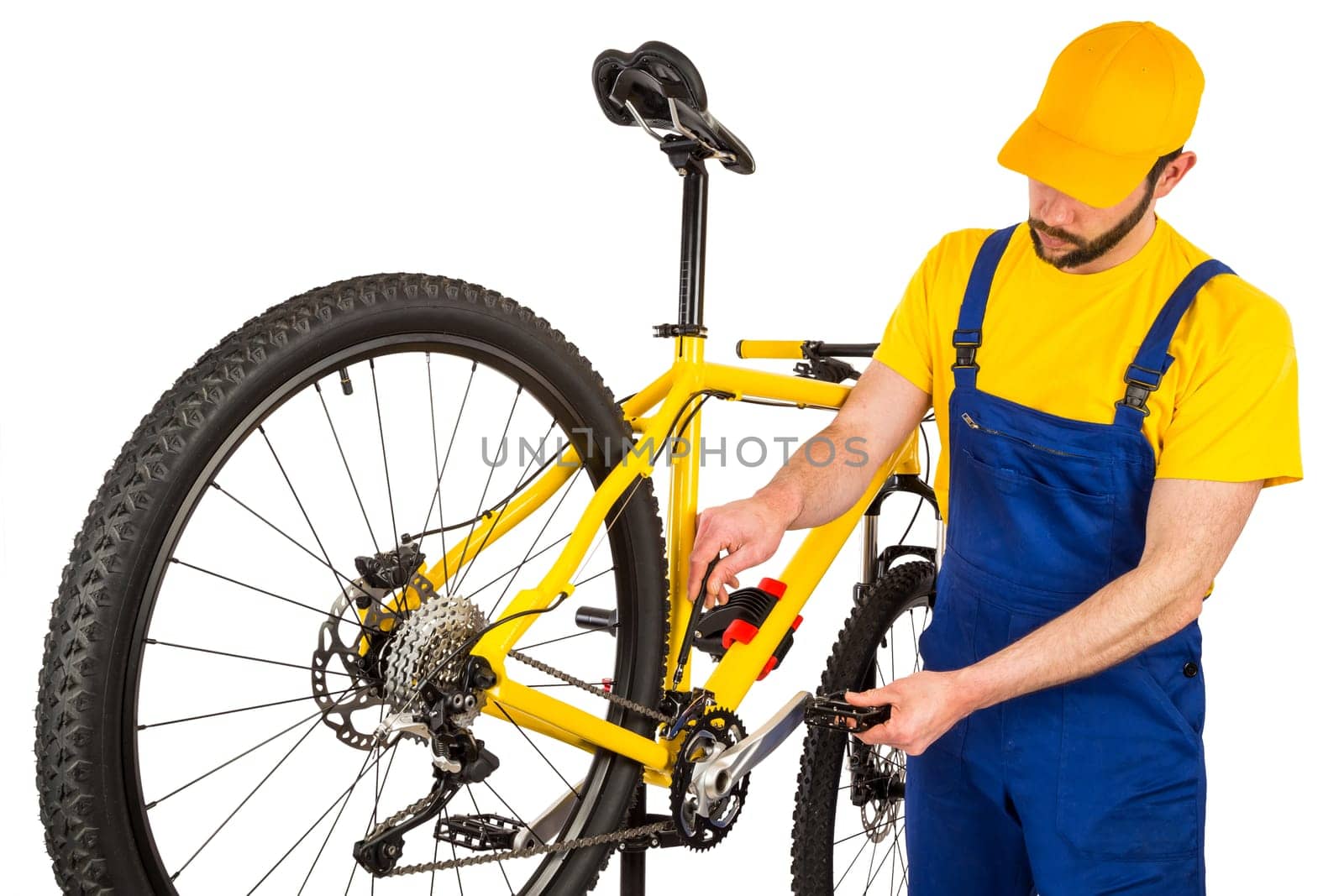 bicycle mechanic adjusting front derailleur mechanism on mountain bike
