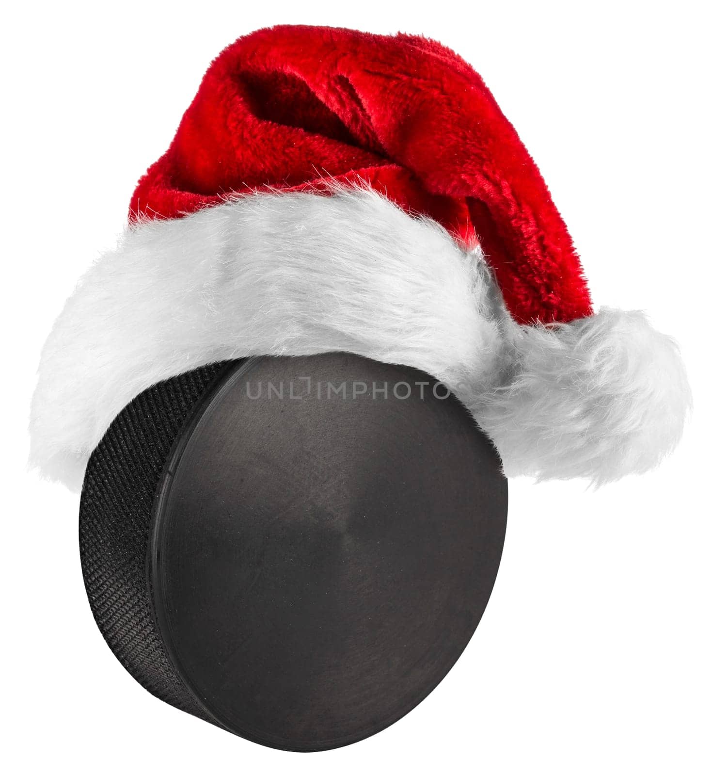 santa hat on ice hockey puck on white background