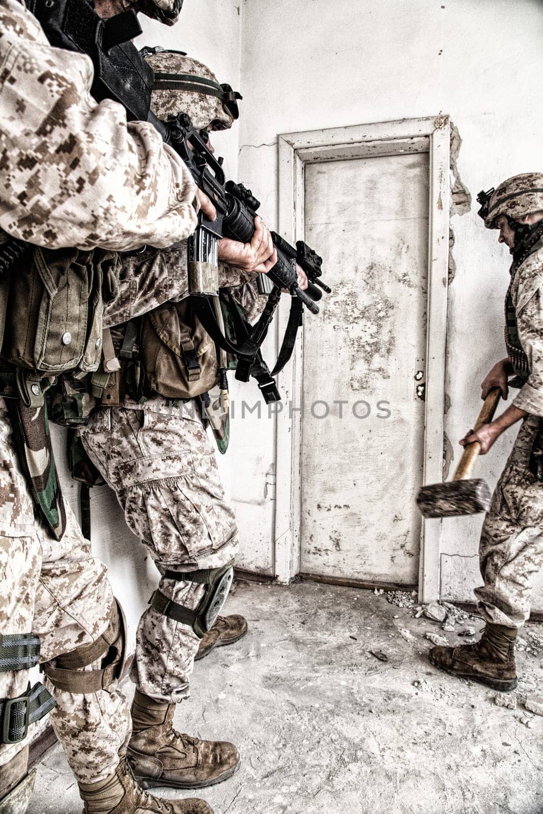 Marine assault team, counter-terrorism squad members, commando fighters in body armor, armed with service rifles, stalking through corridor to closed door, clearing rooms in abandoned city building