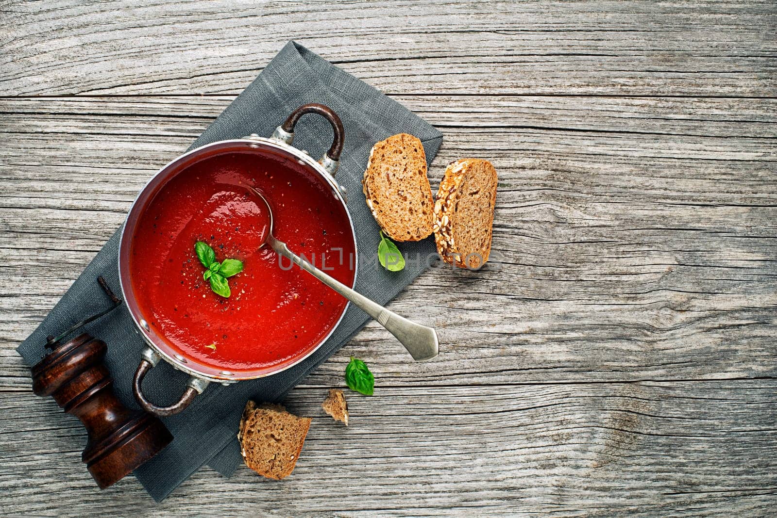 Tomato soup meal with bread on wooden background place for text. Vegan food vegetarian and healthy cooking concept.
