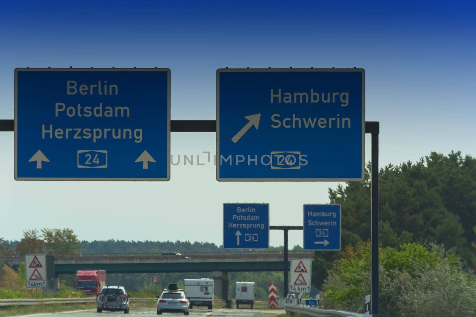 German motorway sign with inscription in German direction arrow to the cities - Berlin, Potsdam, Herzsprung, Hamburg and Schwerin