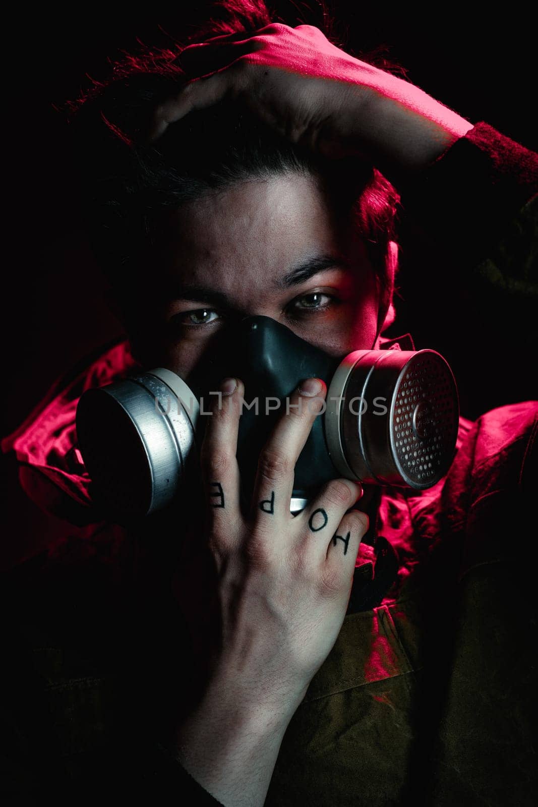 A man in a gas mask on a black background