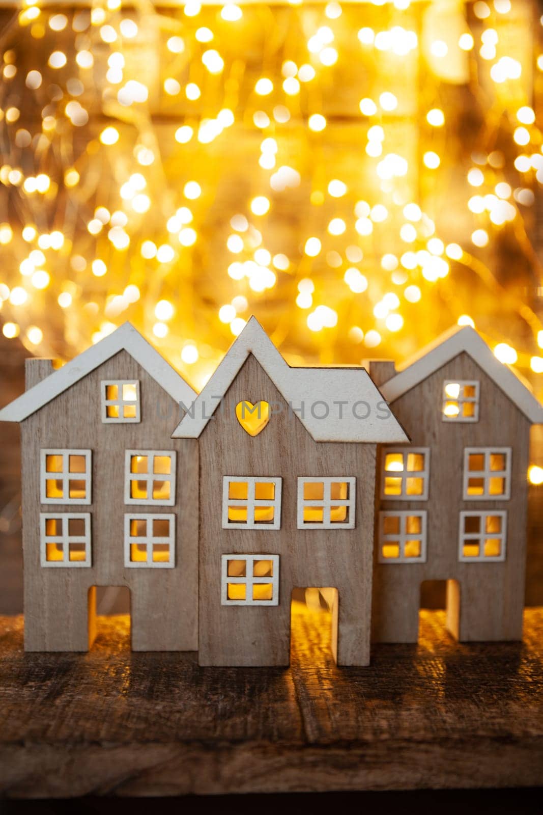 Little wooden houses in front of cozy bokeh lights