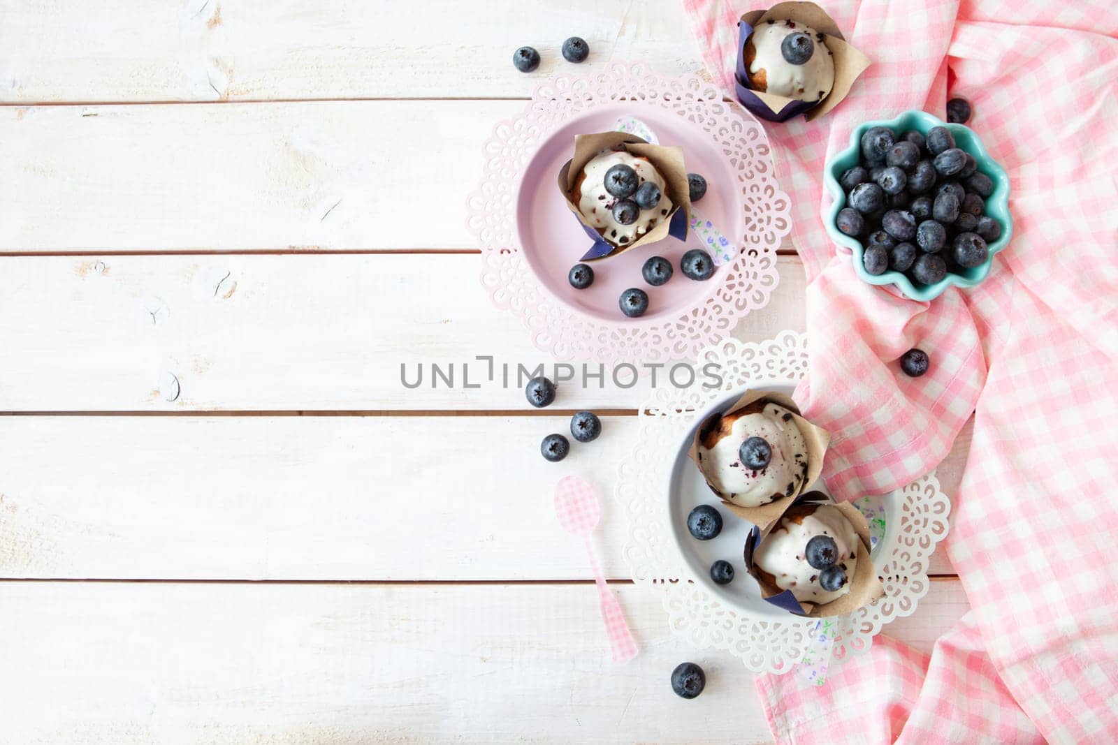 Yummy little muffins with blueberries and sugar frosting