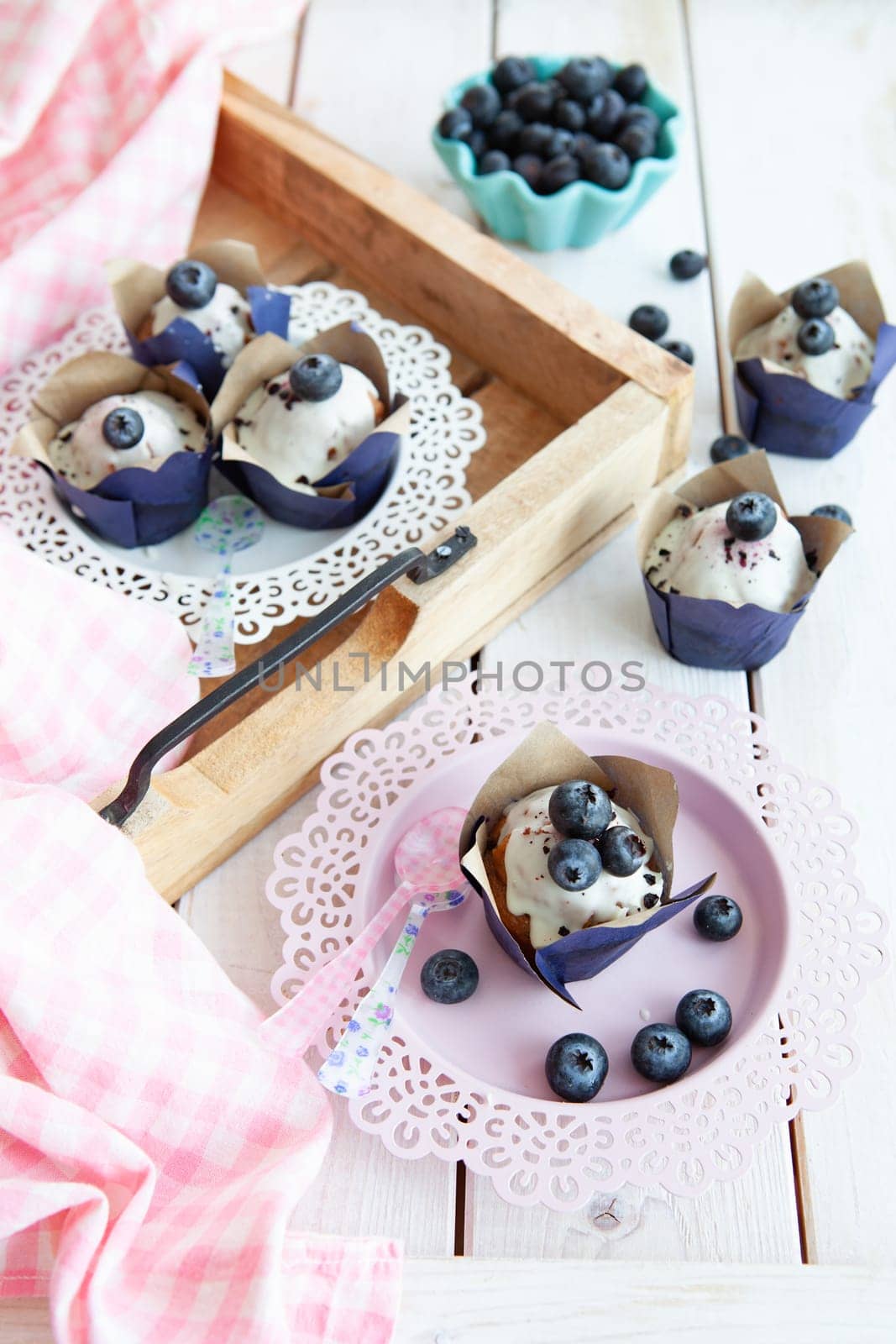 Yummy little muffins with blueberries and sugar frosting