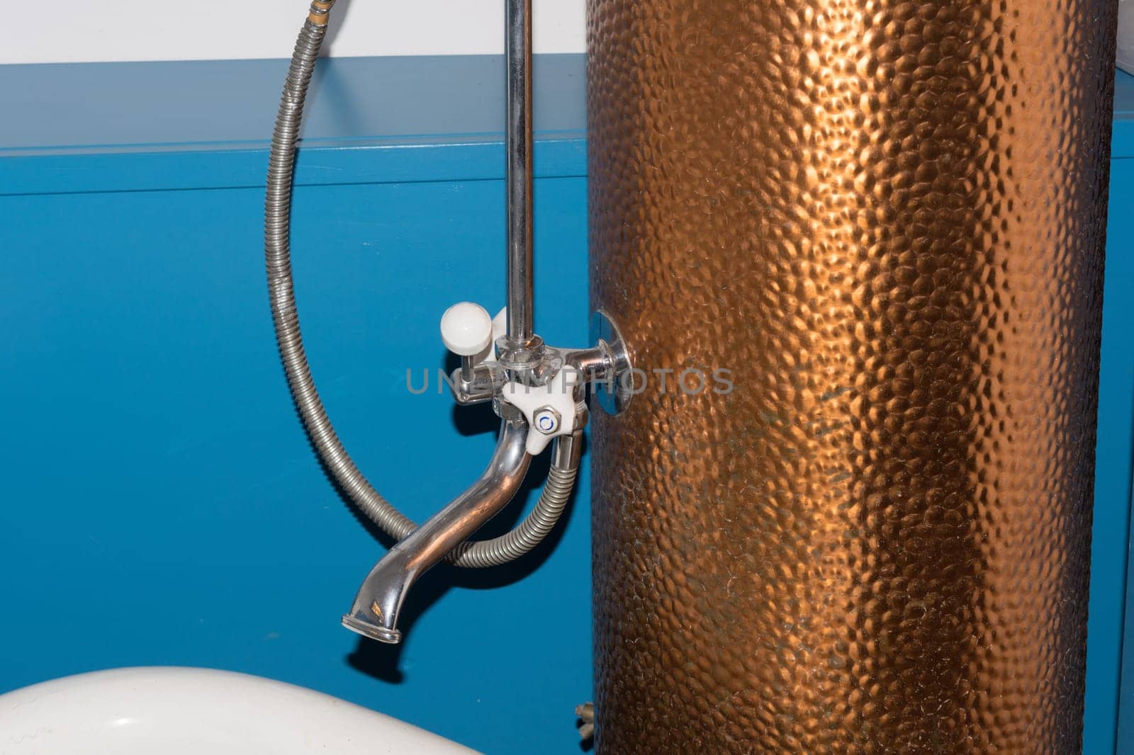 Large old rusty bath water heater made of copper for heating and hot water preparation