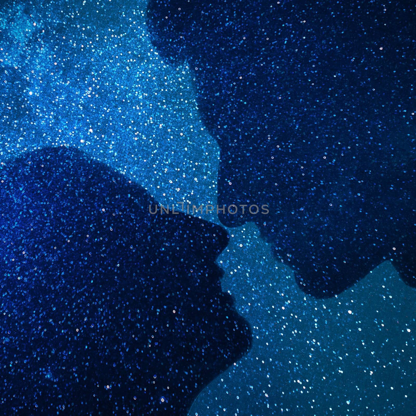 Young couple silhouette hugging and looking at each other outdoors at night stars background
