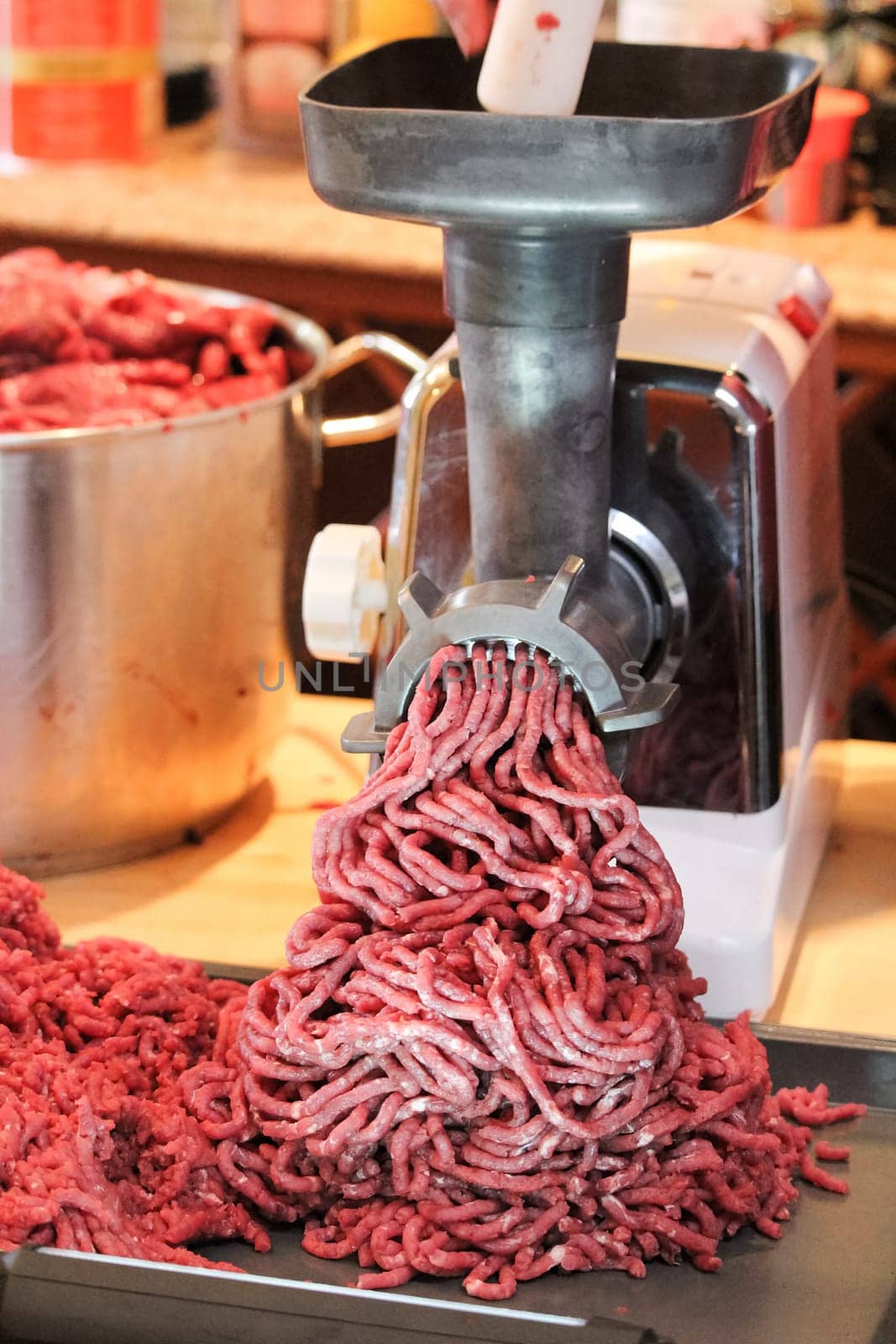 Processing and grinding moose meat at home.