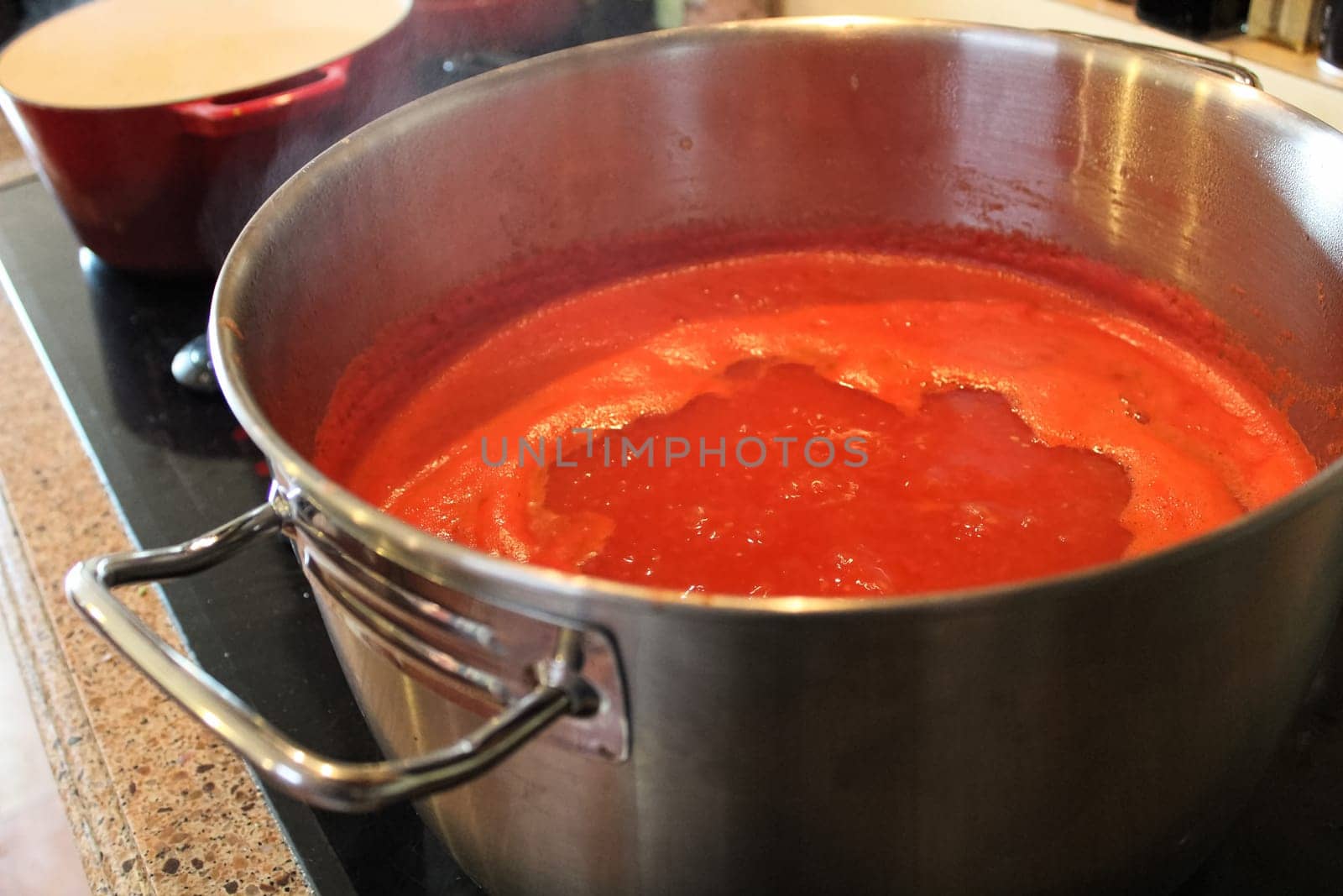 A pot of tomato sauce reducing on the stove.