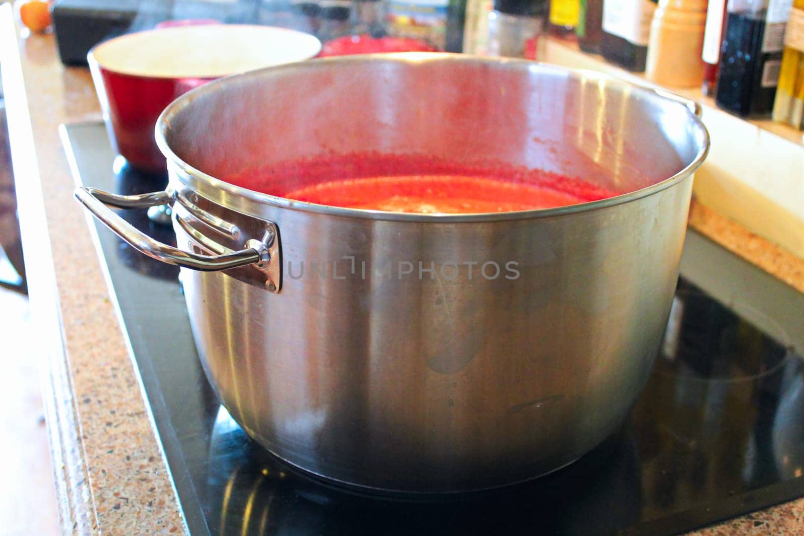 A pot of tomato sauce reducing on the stove.
