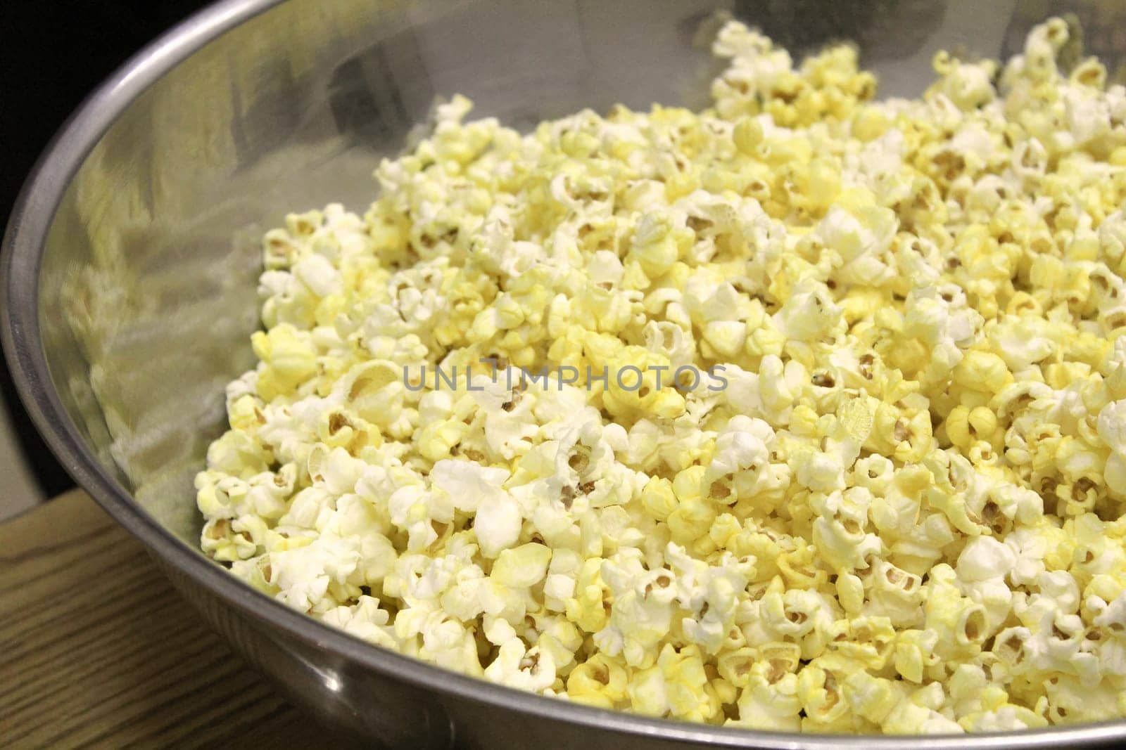 Metal bowl of popcorn ready to be eaten.