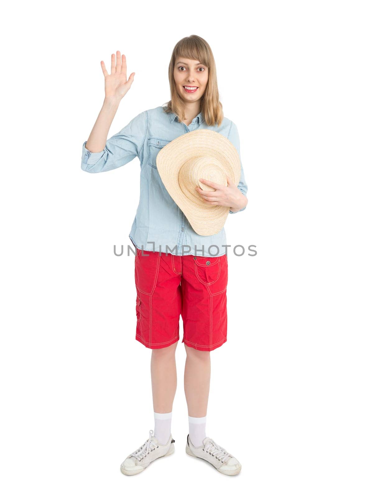 Happy lady tourist in blue shirt and red shorts with straw hat. Girl going to travel. Isolated on white background. Interesting trip on summer vacation.