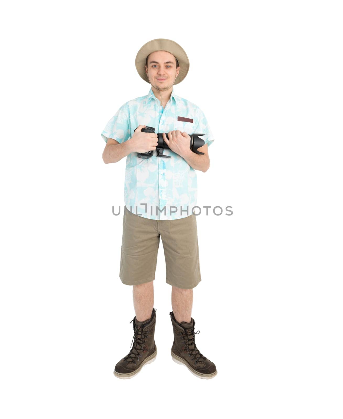 Happy man tourist in blue shirt brown shorts and hat with dslr camera. Traveler going to photo tour. Isolated on white background. Interesting trip on summer vacation.