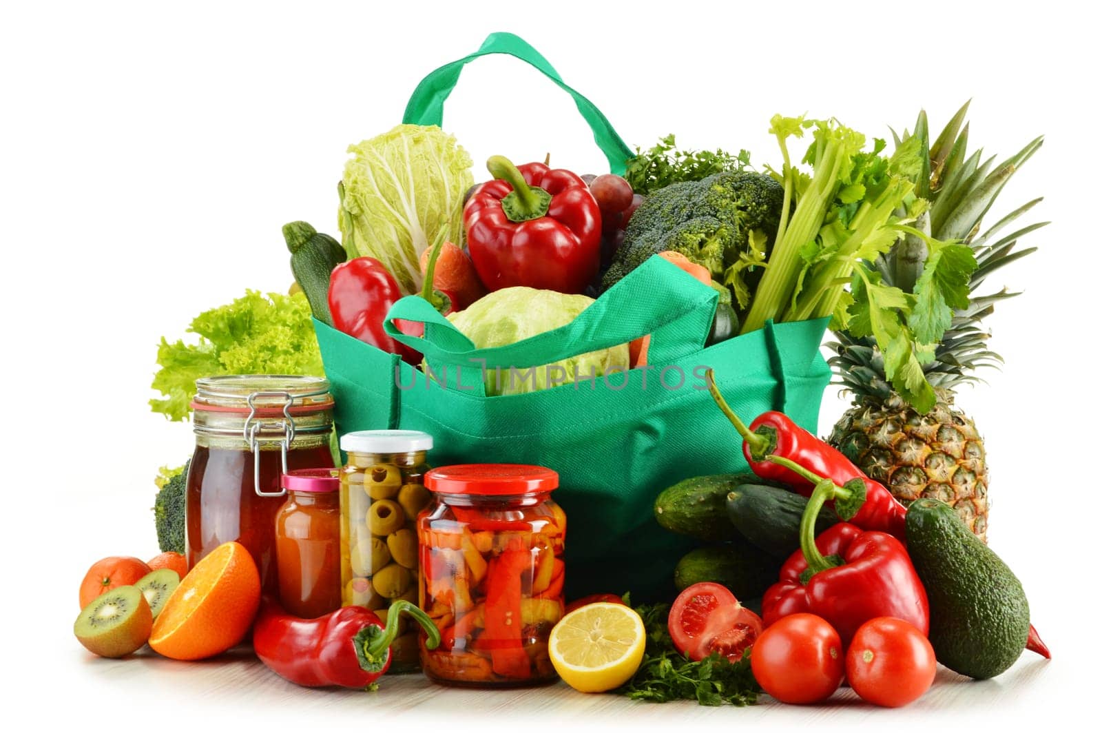 Green shopping bag with groceries isolated on white background