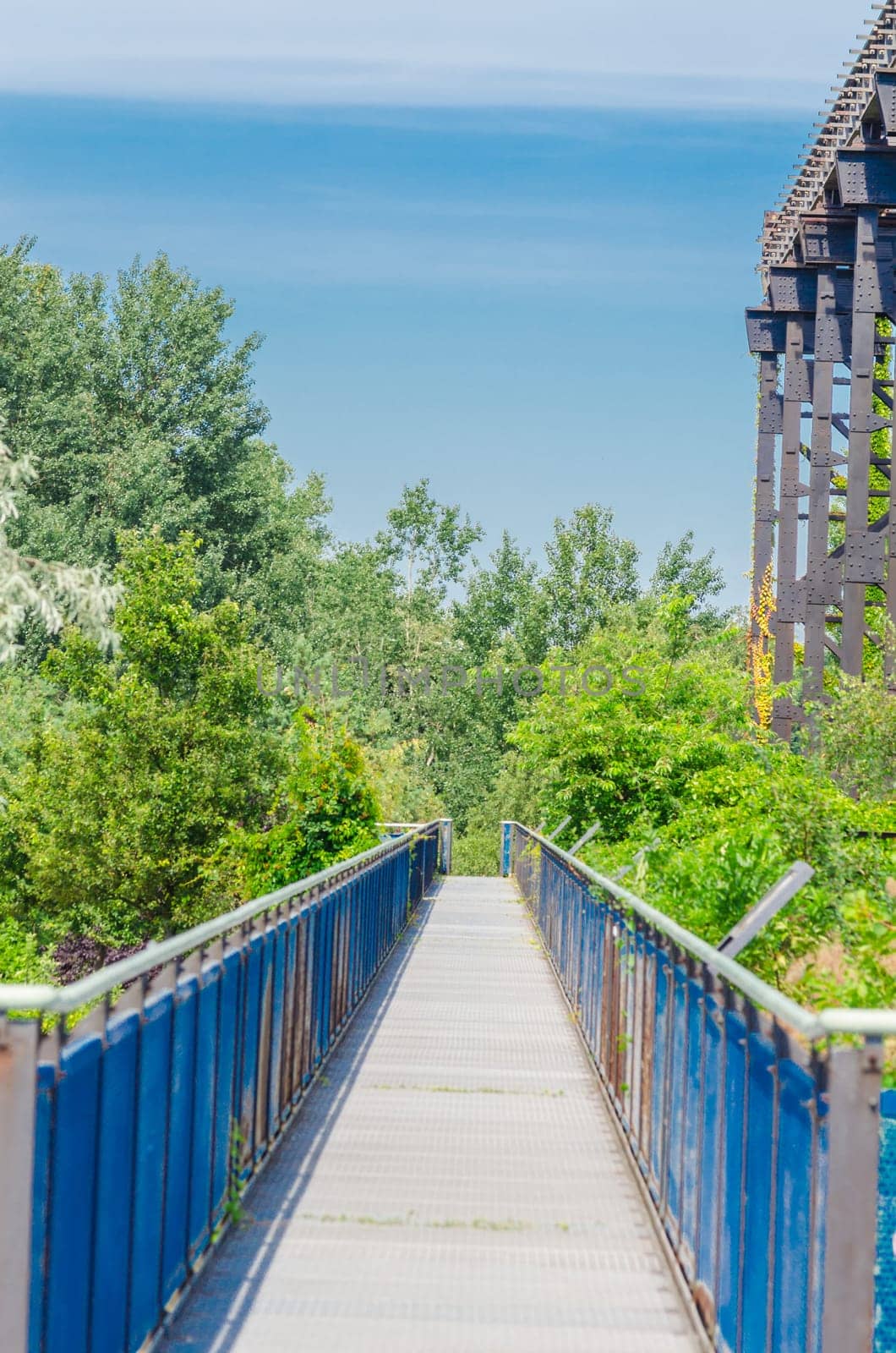 Endless path over a small bridge,in the background the horizon.