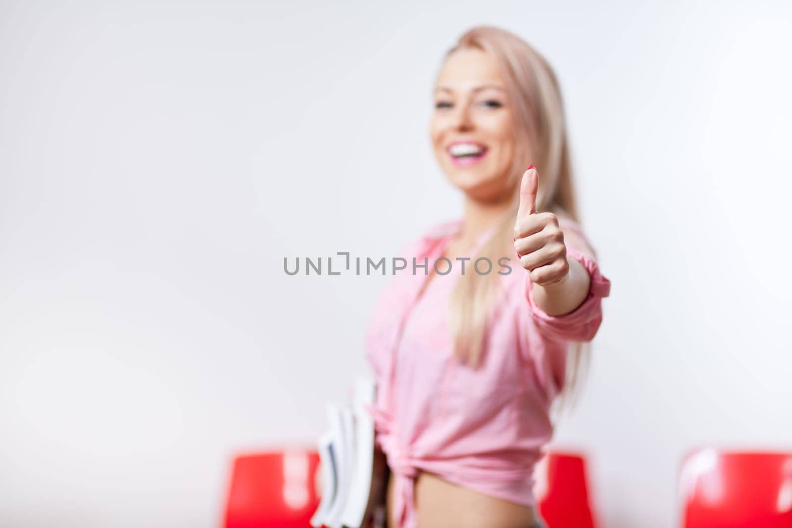 smiling blonde student with her thumb up and smiling