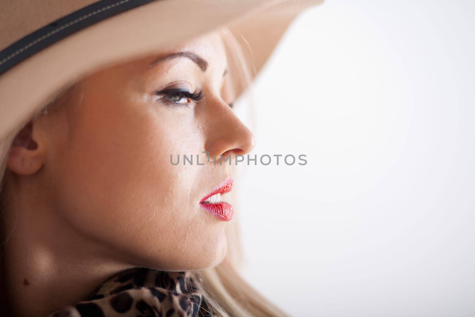 beautiful blonde young woman with red lips long eyelashes and a hat