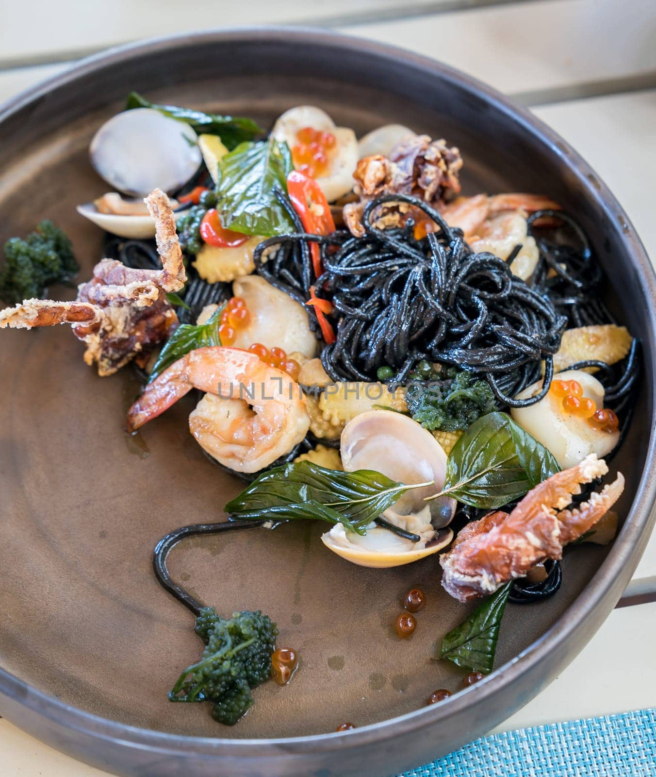 The Mediterranean delicacy food. Black seafood pasta spaghetti  with mussels calm shrimp and crab