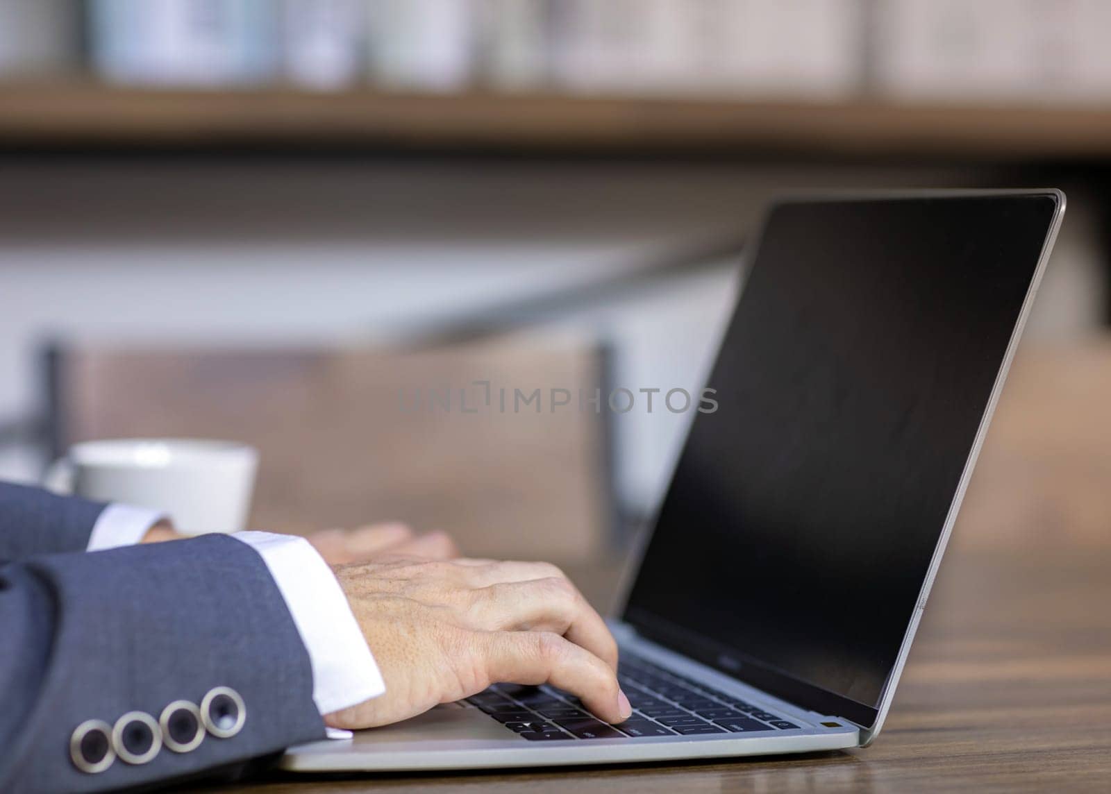 close up of business man working with laptop