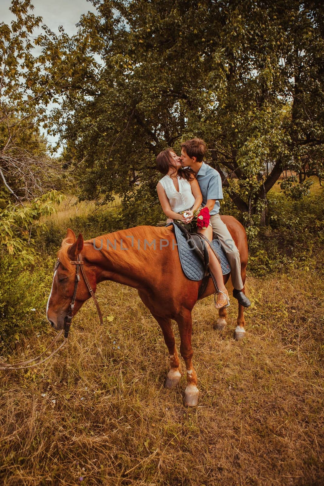 Young beautiful couple with a horse. Filtered. Selective focus.