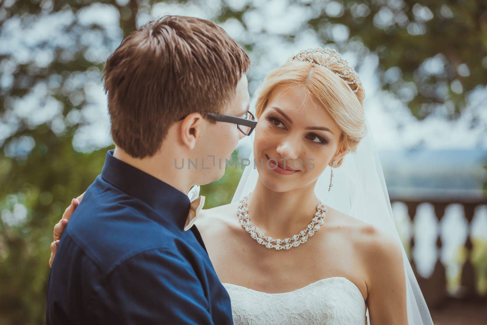 Beautiful young bride and groom in a park