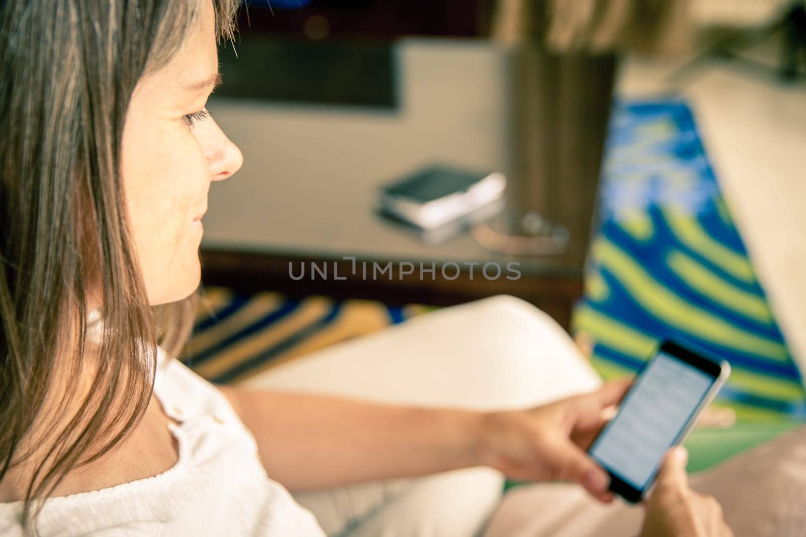 Mature woman is checking messages on her cell phone