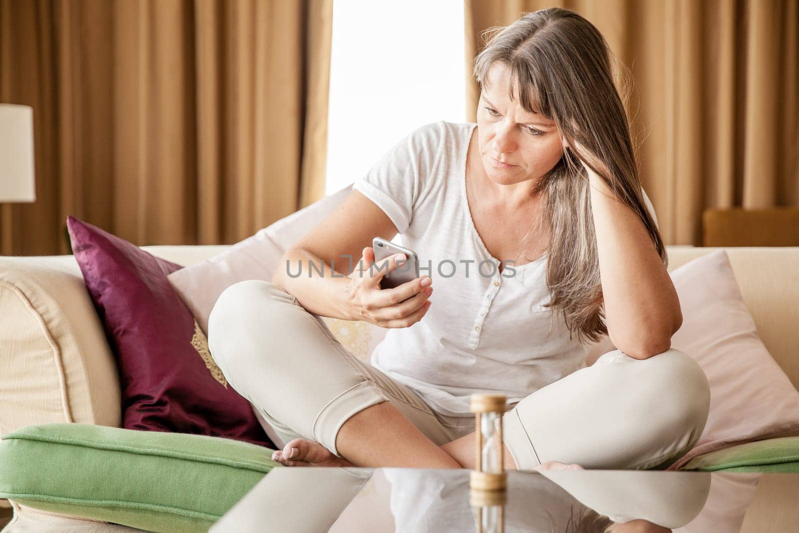 Mature woman is waiting for her phone to ring