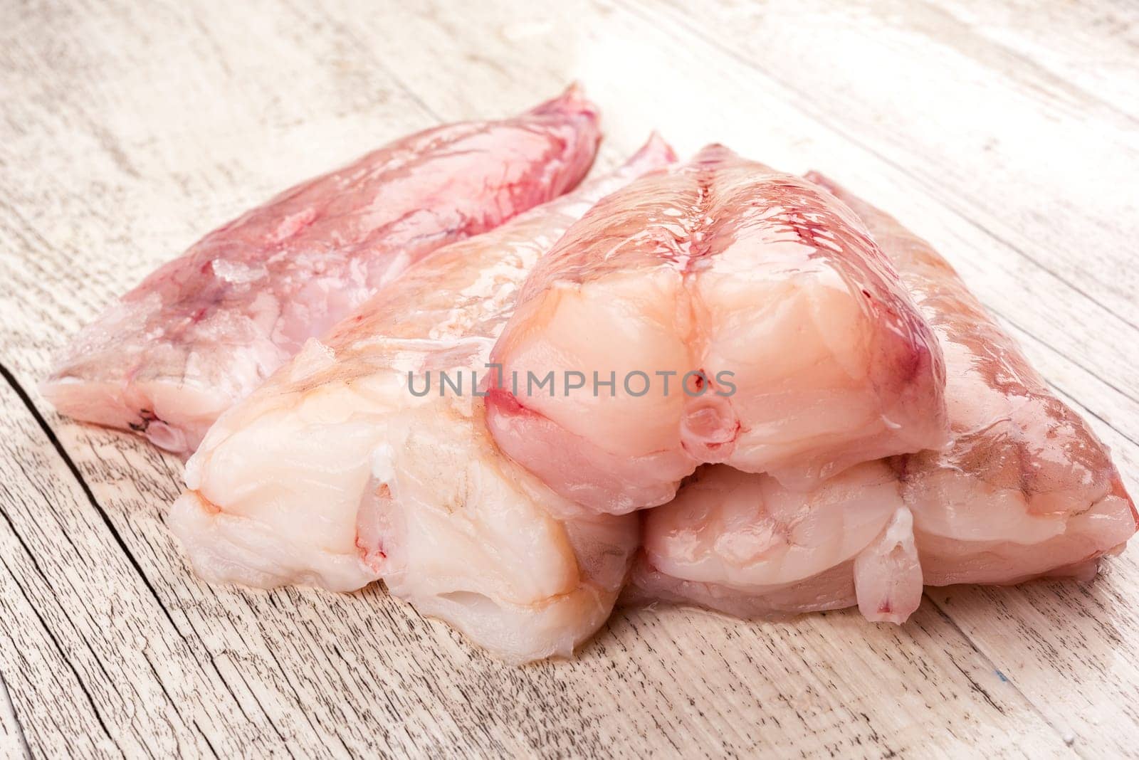 Fresh burbot ready to be cooked, food ingredient on a white old wooden background