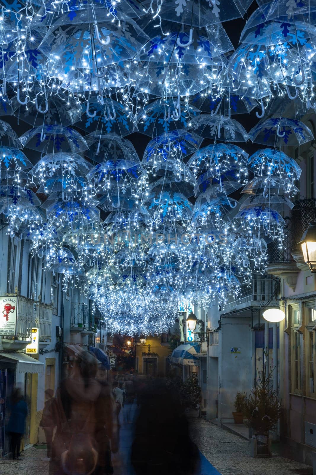 The beauty of white umbrellas iluminated by Christmas lights decorating the streets of Agueda Portugal