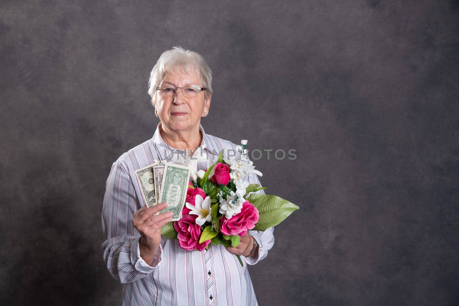 gray hairy elderly woman with flowers and money