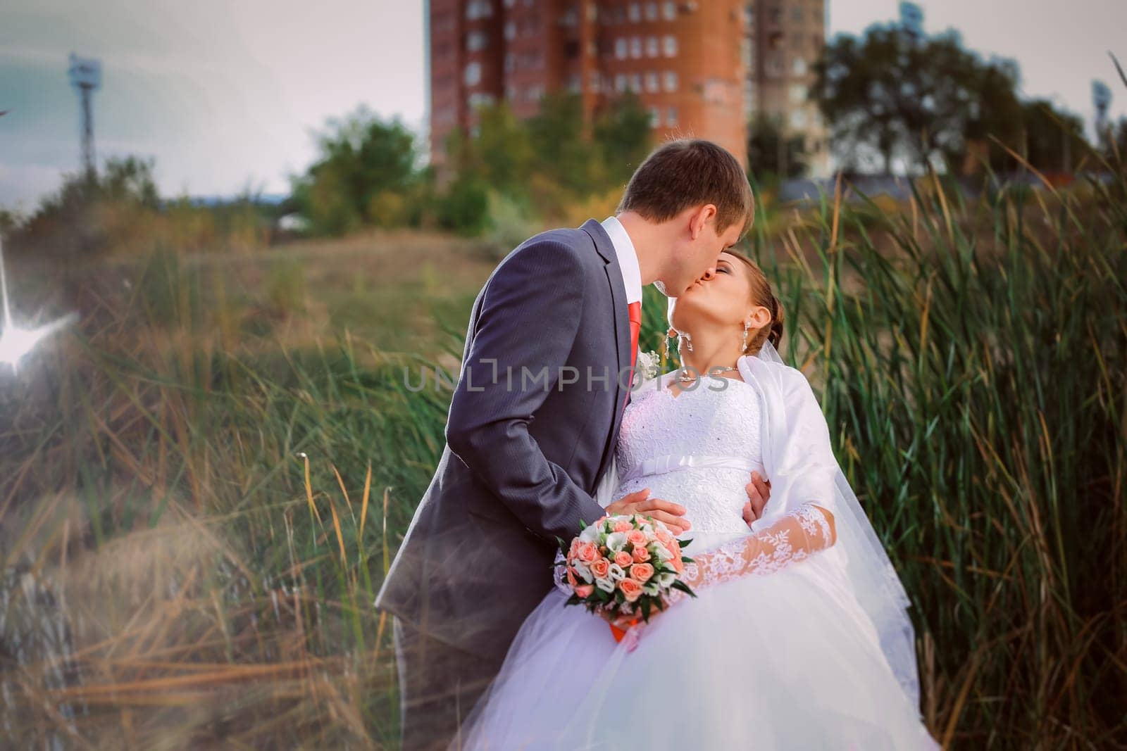 beautiful lovely bridal couple standing near lake