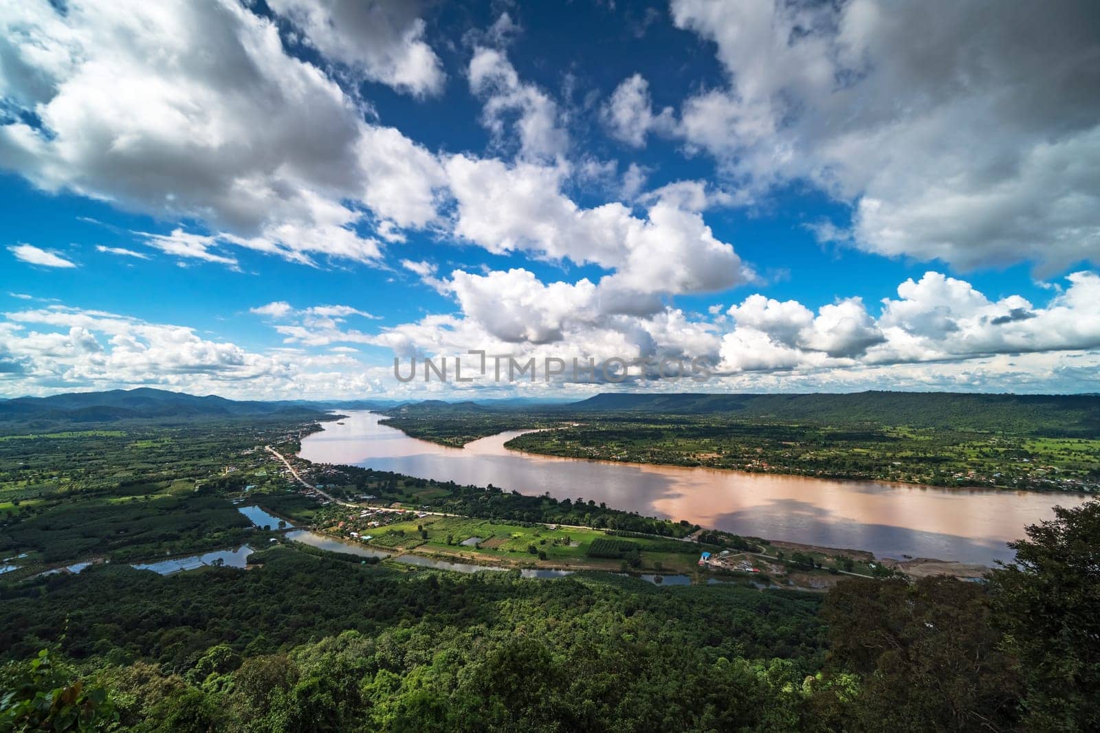 Mekong River At Nong Khai In Thailand, high angle view of landscape with cumulus clouds