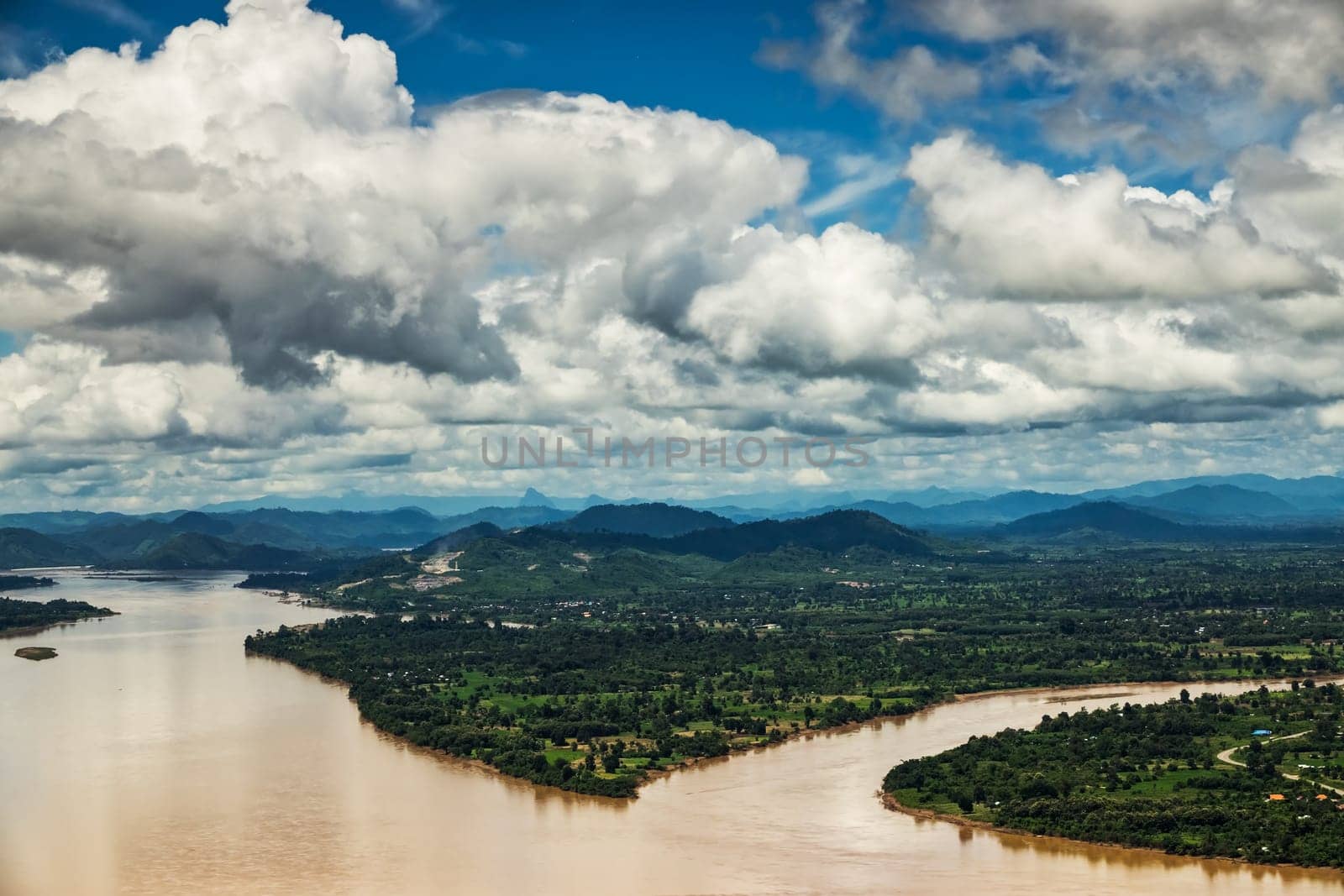 Mekong River At Nong Khai In Thailand, high angle view of landscape with cumulus clouds