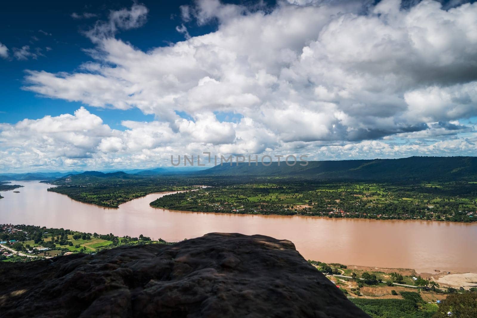 Mekong River At Nong Khai In Thailand, high angle view of landscape with cumulus clouds